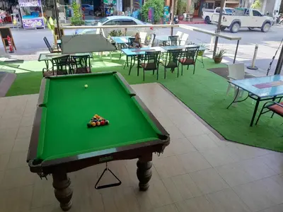 a green pool table with a ball on top of it at Oasis Apartments & Bar in Karon Beach