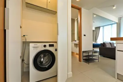 a washing machine in a room with a living room at Oceanstone by Holy Cow, studio, next building view in Bang Tao Beach