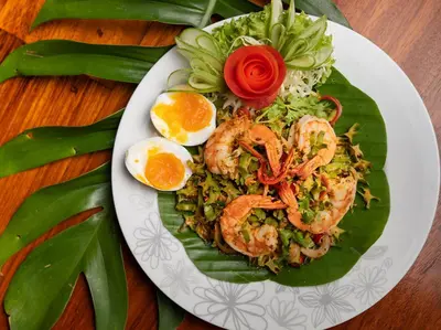 a plate of food with shrimp and rice and an egg at Villa Chada in Kamala Beach
