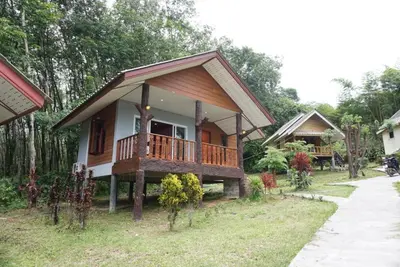 a small house with a porch and a balcony at Mookanda bungalow in Ko Yao Noi