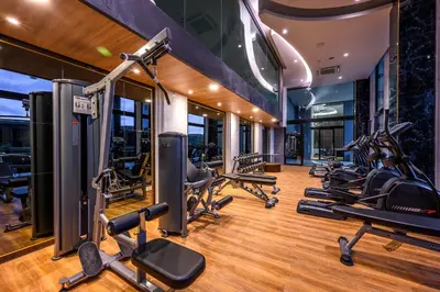 a gym with treadmills and cardio equipment in a building at Mida Grande Resort Phuket Official Account in Surin Beach