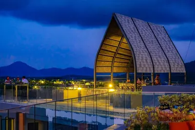 a view of a building at night at Mida Grande Resort Phuket Official Account in Surin Beach