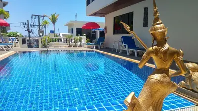 a swimming pool with a gold mermaid statue next to it at Blue Sky Residence in Patong Beach