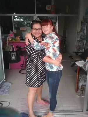 two women hugging each other in a room at We Love Kata in Kata Beach