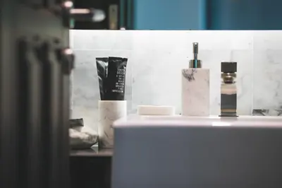 a bathroom counter with bottles of cosmetics on it at The Infinity Private Pool Villa in Phuket Town