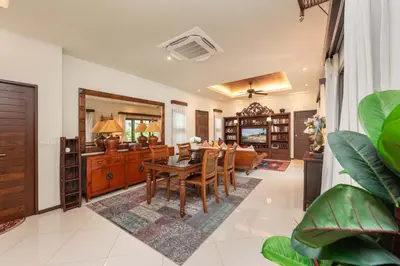 a living room with a table and a couch at VILLA LETI 22 meters Pool Naiharn Beach in Rawai Beach