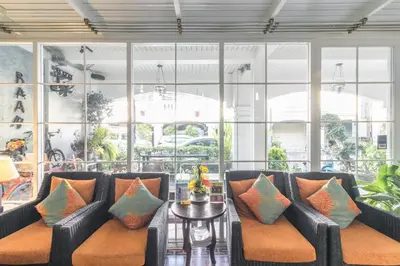 a lobby with couches and a table with pillows at Baan PhuAnda Phuket in Phuket Town