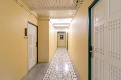 a hallway with a door and a tile floor at Baan PhuAnda Phuket in Phuket Town