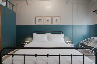 a bed in a room with blue and white walls at Blu Monkey Boutique Phuket Town in Phuket Town