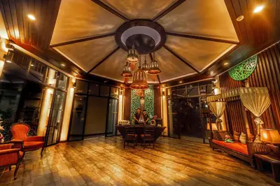 a large living room with a chandelier and wooden floors at Navatara Phuket Resort in Rawai Beach