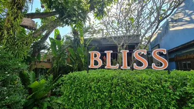 a sign that says bliss on top of a hedge at Bliss Resort Krabi in Klong Muang Beach