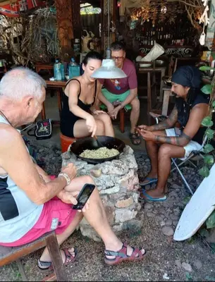 a group of people sitting around a fire pit at Ko Yao Noi Sabai Bungalows in Ko Yao Noi