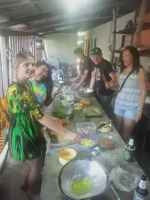 a group of people standing in a kitchen preparing food at Ko Yao Noi Sabai Bungalows in Ko Yao Noi