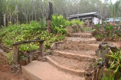 a garden with stone steps in front of a house at Camp Hadee Koh Yao Noi in Ko Yao Noi