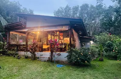 a small house with a porch and a yard at Najjamee Bungalows in Ko Yao Noi