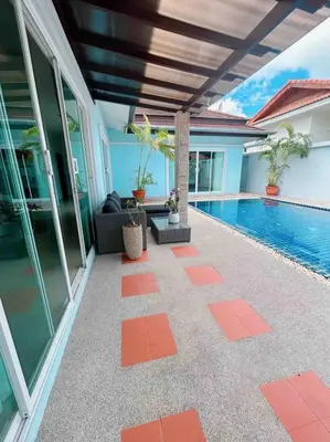 a patio with a swimming pool next to a house at Bests Villa - Rawai Beach Phuket in Rawai Beach