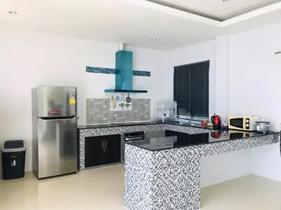 a kitchen with a refrigerator and a counter top at Bests Villa - Rawai Beach Phuket in Rawai Beach