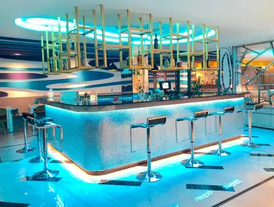 a bar in a restaurant with stools around it at Ratana Platinum Resort Kamala in Kamala Beach