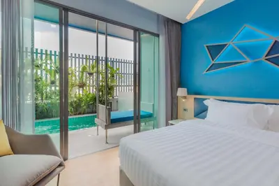 a bedroom with a bed and a view of a pool at BlueSotel SMART Krabi Aonang Beach - Adults only in Ao Nang Beach