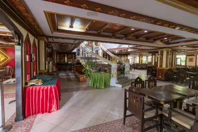 a restaurant with tables and chairs and a staircase at Ayodhaya Palace Beach Resort - SHA Plus certified in Ao Nang Beach