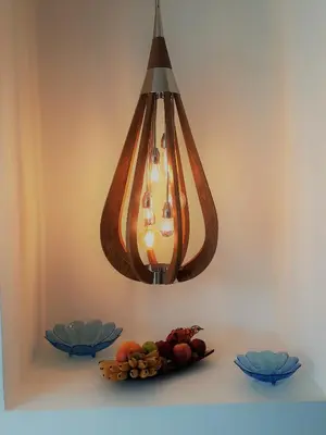 a chandelier hanging over a table with a plate of fruit at Villa KHAO MANEE in Nai Yang Beach