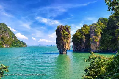 a small island in the water in the middle of the ocean at Villa on The Rocks, 4 bedrooms, Phuket in Surin Beach