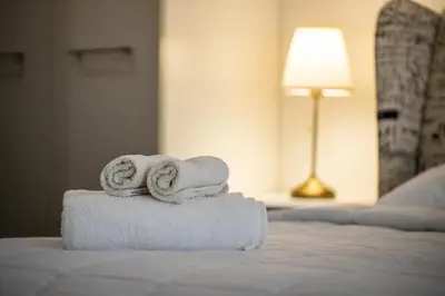 a pile of towels sitting on top of a bed at Villa Status in Nai Harn Beach