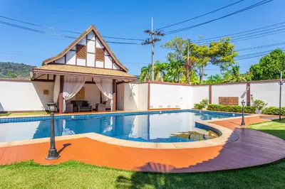 a house with a swimming pool and a gazebo at Villa Status in Nai Harn Beach