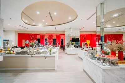 a restaurant with red walls and tables with flowers at SLEEP WITH ME HOTEL design hotel @ patong (SHA Plus+) in Patong Beach