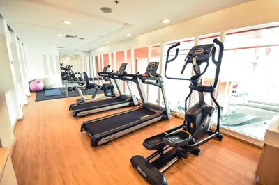 a row of treadmills in a gym with exercise bikes at SLEEP WITH ME HOTEL design hotel @ patong (SHA Plus+) in Patong Beach