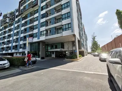 a woman walking in front of a building at 2 Floor - Centrio Condominium near Central Shopping Mall and Phuket Old town in Phuket Town