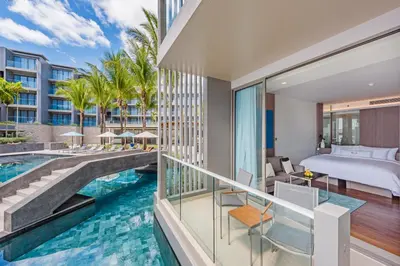 a view of a hotel room with a pool and a bed at Oceanfront Beach Resort in Patong Beach