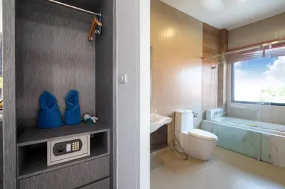 a bathroom with a toilet and a sink and a tub at The Thames Pool Access Resort & Villa - SHA Extra Plus in Chalong