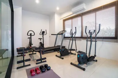 a gym with cardio equipment in a room at The Thames Pool Access Resort & Villa - SHA Extra Plus in Chalong