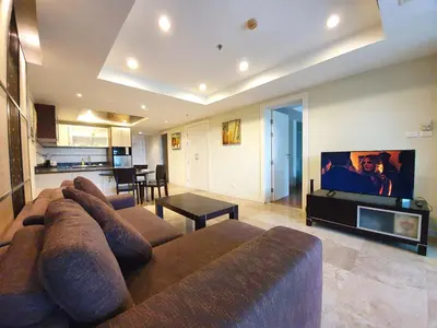 a living room with a large couch and a tv at Spacious apartment with Ocean view in Panwa in Phuket Town