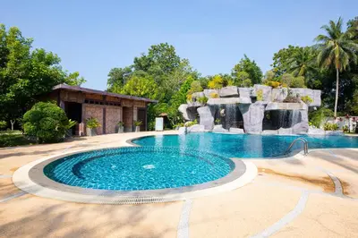 a large swimming pool with a water fountain at Rnana Grand in Phangnga