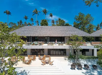 a resort with a pool and chairs and palm trees at Island Escape Burasari in Phuket Town