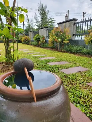 a bird bath with a wooden stick in it at Thap Kaek B2 Villa in Klong Muang Beach