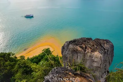 a boat in the water next to a beach at Thap Kaek B2 Villa in Klong Muang Beach