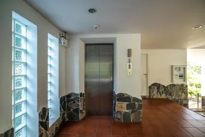 a hallway with a door in a building at Kata Ocean View condominium by Lofty in Kata Beach