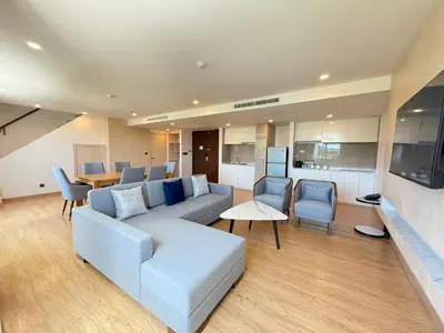 a living room with a couch and a table at Wyndham La Vita Rawai Phuket in Rawai Beach