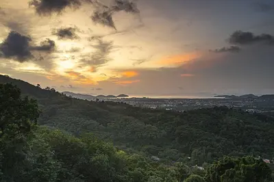 a view of a city from a hill at sunset at Phuket View Coffee and Resort in Chalong