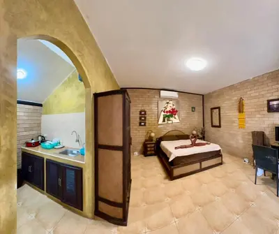 a large room with a bed and a sink at Sanuk bungalows in Rawai Beach