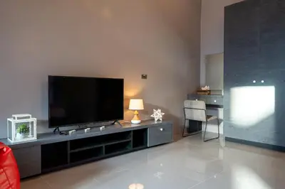 a living room with a flat screen tv on a entertainment center at La Belle Pool Villa Phuket - Home Away from HOME in Bang Tao Beach