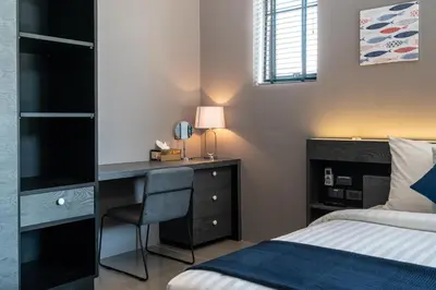a bedroom with a desk and a bed and a bed and a bed at La Belle Pool Villa Phuket - Home Away from HOME in Bang Tao Beach