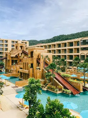 a resort with a swimming pool and a water slide at Pamookkoo in Kata Beach