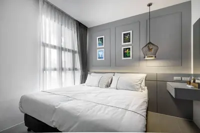 a bedroom with a large white bed and a sink at PALMYRAH SURIN, MODERN 1BR with Terrace, 150 meters to Surin Beach in Surin Beach