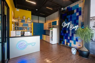 a store with a refrigerator and a counter in a room at Patong Poshtel in Patong Beach