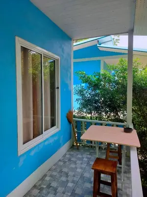 a patio with a table and a window at Baan seefa homestay kohyaoyai in Ko Yao Yai