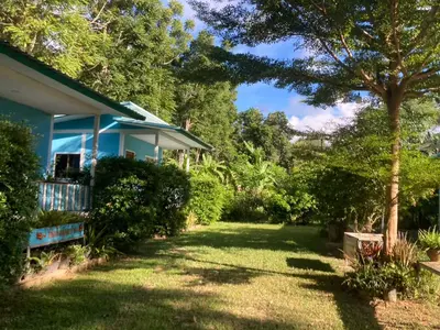 a house with a yard in front of it at Baan seefa homestay kohyaoyai in Ko Yao Yai